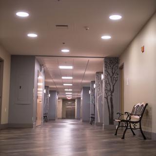 A well-lit, modern hallway featuring a bench and contemporary decor.