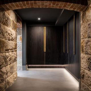 Modern hallway with stone walls and sleek lighting.