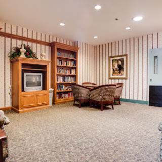 Cozy living area featuring a bookshelf, comfortable seating, and a television.