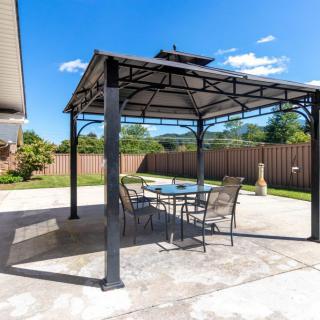 A sunny backyard patio with a gazebo and outdoor furniture.