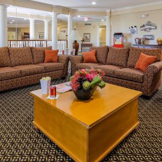 Cozy seating area with sofas and a coffee table in a welcoming lobby.