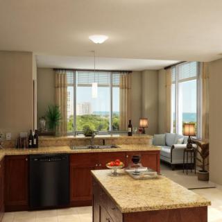 A modern open space design featuring a kitchen with an island and an adjoining living area.