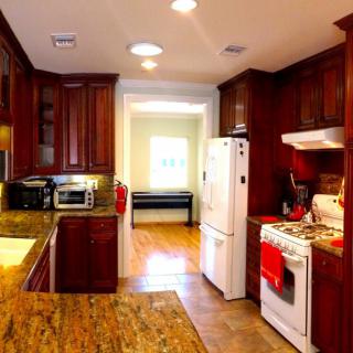 A warm and inviting kitchen with wooden cabinets, modern appliances, and a spacious countertop.