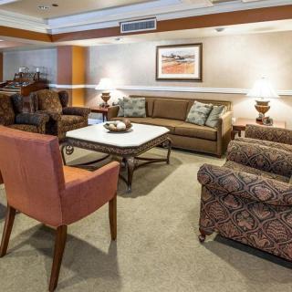 A cozy living room with comfortable seating and warm lighting.
