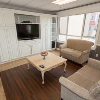 A cozy and modern living room with a comfortable sofa, coffee table, and a television.