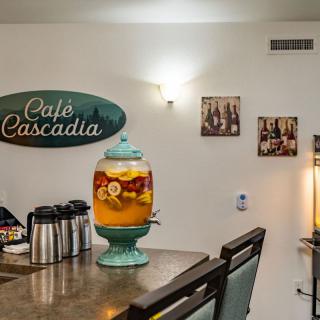Interior of Caf Cascadia with a beverage dispenser and cozy decor.