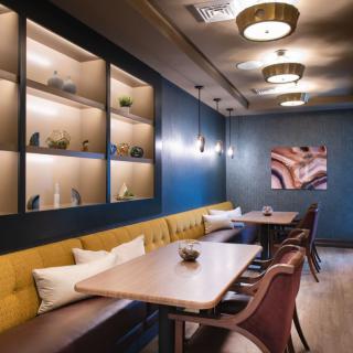 A modern restaurant interior featuring stylish seating and warm lighting.