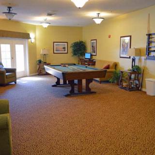 A cozy game room featuring a pool table and comfortable seating.