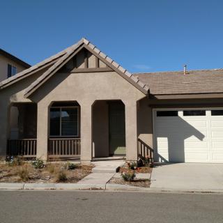 A suburban residential house with a garage and front porch.