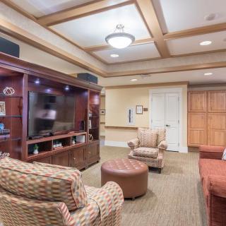 A cozy living room with an entertainment center and comfortable seating.