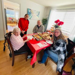 A lovely gathering around the dinner table, sharing joy and delicious food.