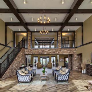 A luxurious and elegantly designed lobby with high ceilings, plush seating, and sophisticated lighting.