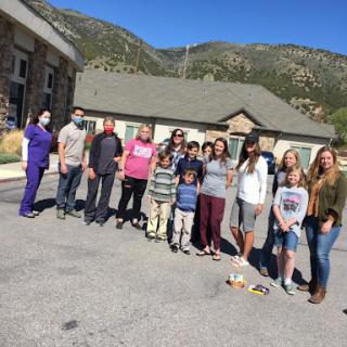 A cheerful gathering of community members enjoying a sunny day in the mountains.