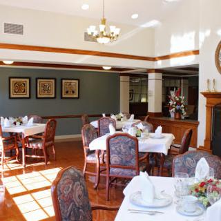 An elegant dining room setup with beautifully arranged tables and chairs.