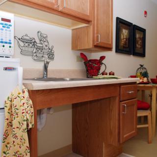 Cozy kitchen area with a sink, cabinets, and decorative elements.