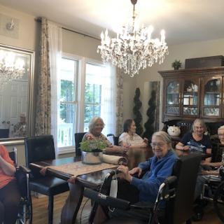 A group of seniors enjoying time together in a cozy activity room.
