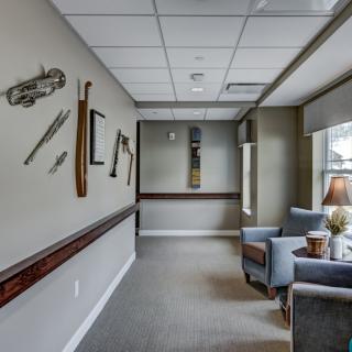 A modern hallway with decorative wall art and comfortable seating.