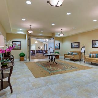 A welcoming lobby area featuring comfortable seating, decorative plants, and soft lighting.