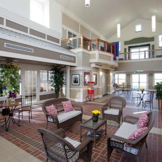 A spacious and modern living area with loft design, featuring comfortable seating and abundant natural light.