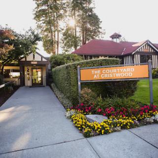 The welcoming entrance of the Countryside Resort, adorned with vibrant flowers and lush greenery.