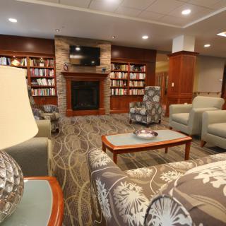 A cozy living room with bookshelves and a fireplace.