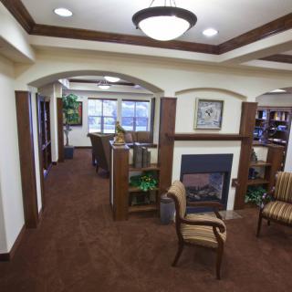 A cozy lobby interior with a fireplace, comfortable seating, and elegant lighting.