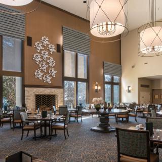 Spacious restaurant dining area with elegant decor and high ceilings.