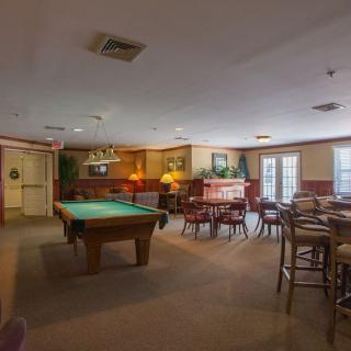 A cozy pub interior featuring a pool table and seating area.