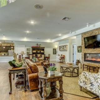 A spacious and cozy living room with elegant furniture and a modern fireplace.