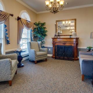 A traditional living room with elegant furnishings and a cozy fireplace.