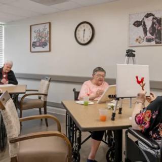 Seniors participating in an art class at a nursing home.