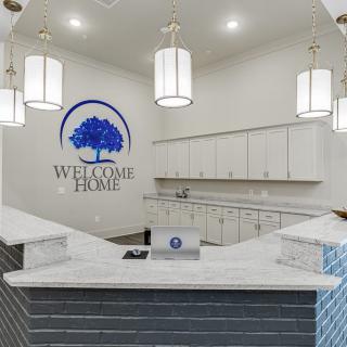 A modern reception area with a welcoming desk and elegant lighting.