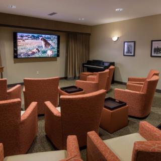 A cozy theater room with comfortable seating and a large screen for viewing.