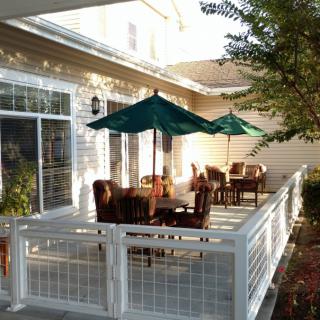 A cozy patio with outdoor furniture and umbrellas on a sunny day.