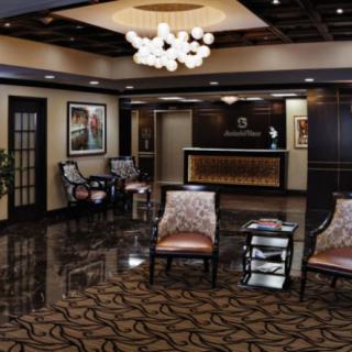 A modern lobby with stylish furniture and a reception desk.