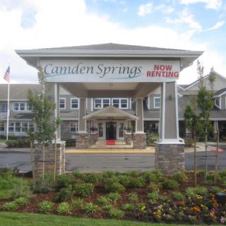 Entrance of a retirement home with well-maintained landscaping.
