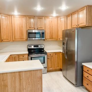 A modern kitchen with wooden cabinets and stainless steel appliances.