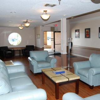 A comfortable lounge area with armchairs and a coffee table, ideal for waiting or relaxation.