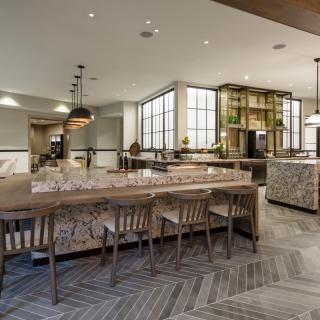 A modern restaurant interior with wooden furniture and contemporary lighting.