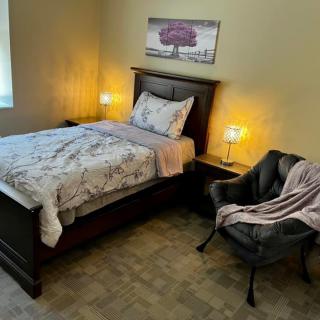 A cozy bedroom with a neatly made bed and stylish decor.