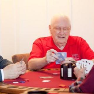 A group of people enjoying a game of poker indoors.