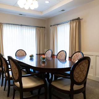 A well-appointed dining room with a large table and elegant chairs.