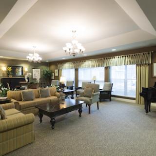 A spacious and elegantly designed living room featuring comfortable seating, decorative elements, and abundant natural light.