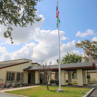 A building with a flagpole on a cloudy day.