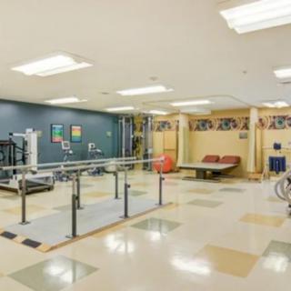 A rehabilitation room equipped with physical therapy and exercise equipment.