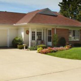 A suburban house with a well-maintained front yard and driveway.
