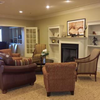 A cozy living room with a fireplace and comfortable seating arrangement.