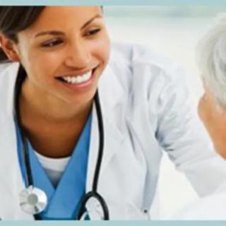 A smiling healthcare professional interacting with a patient.