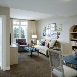 A cozy living room with modern furniture and decorative elements.