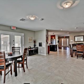 A modern open living and dining area with a view into the kitchen.